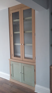 Cabinets with floating shelves and glass doors.