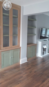 Cabinets with floating shelves and glass doors.